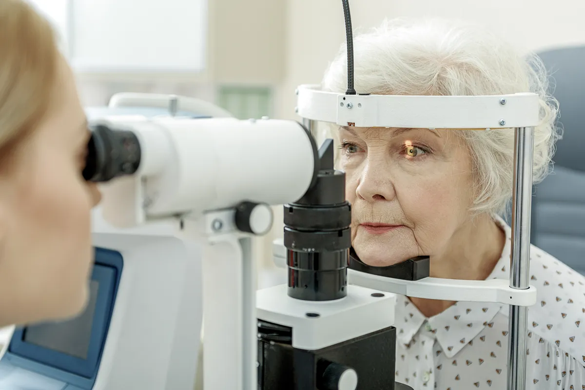 Elderly woman undertaking an eye examination